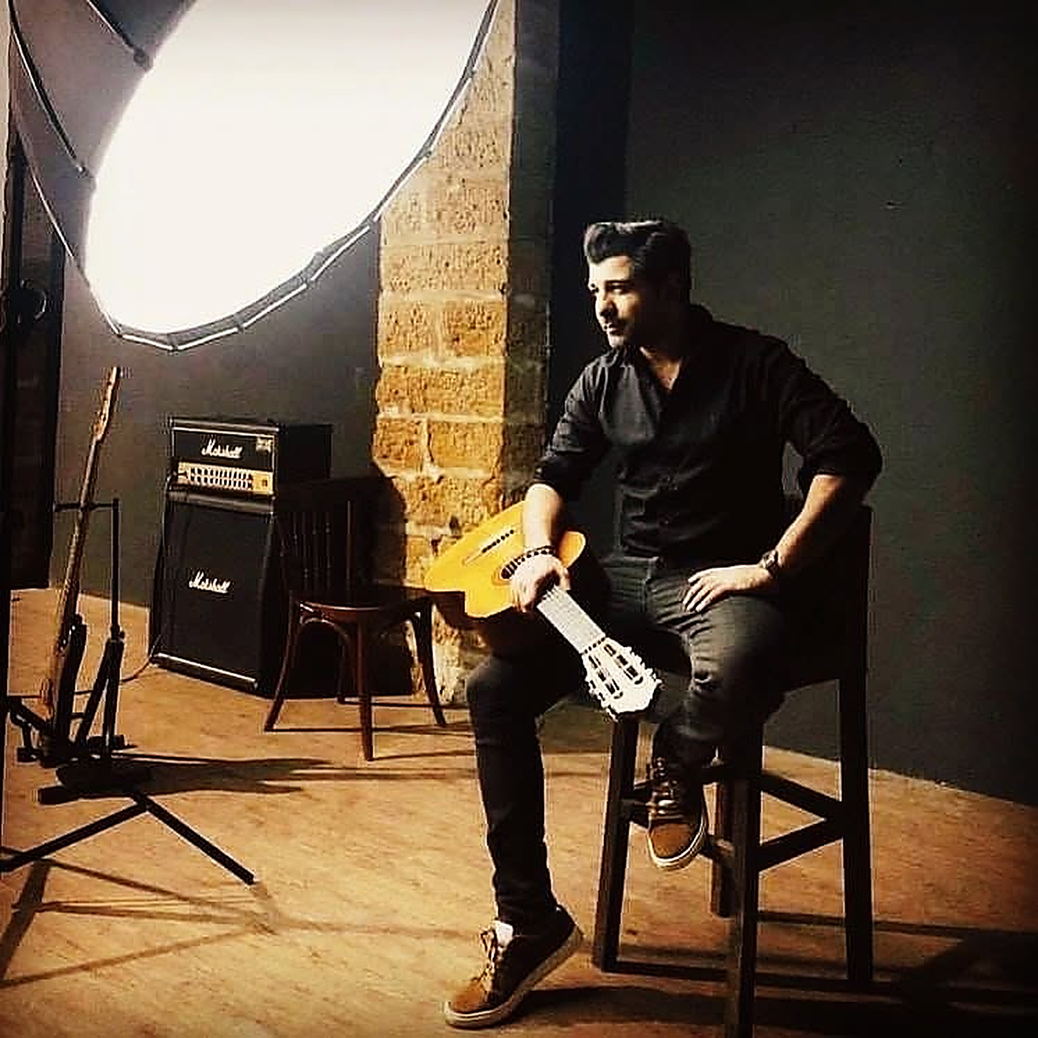 Shuja Haider in the studio with a guitar